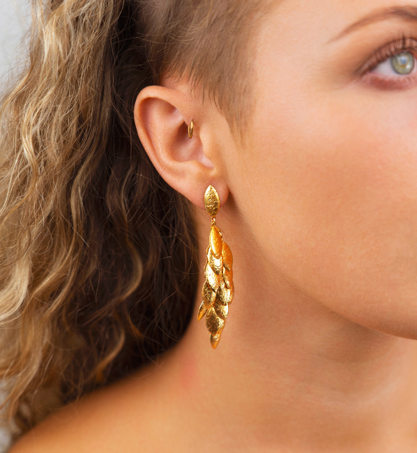 Model wearing leaf earrings