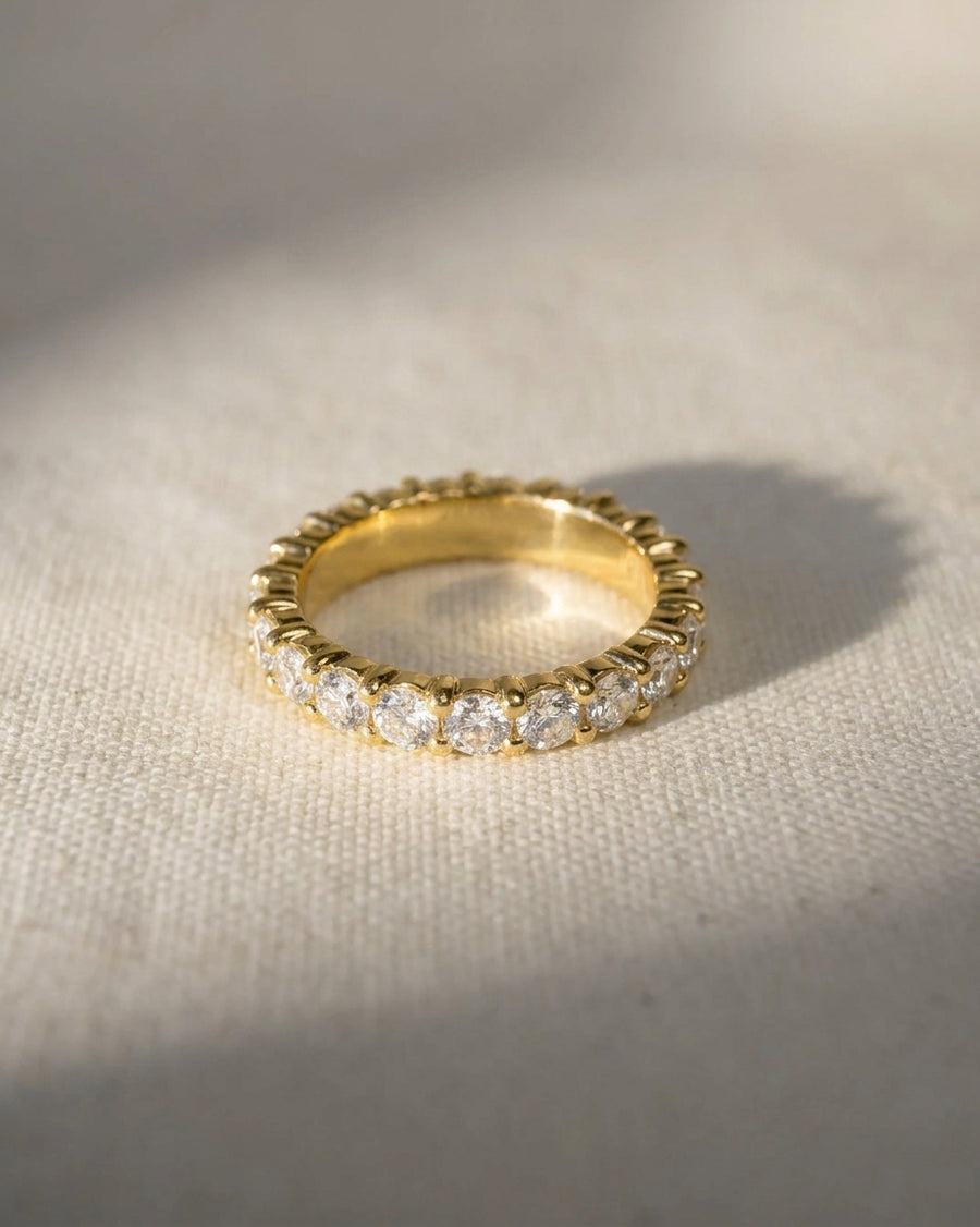Gold full eternity ring with claw set round diamonds.
