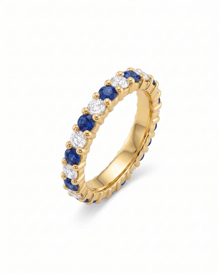 Gold full eternity ring with claw set blue sapphires and white diamonds.