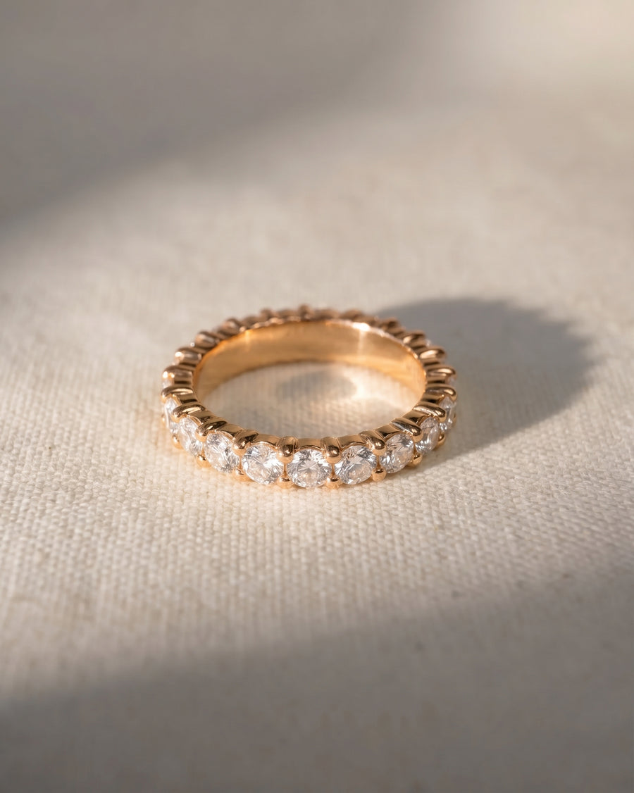 Rose gold full eternity ring with claw set round diamonds.