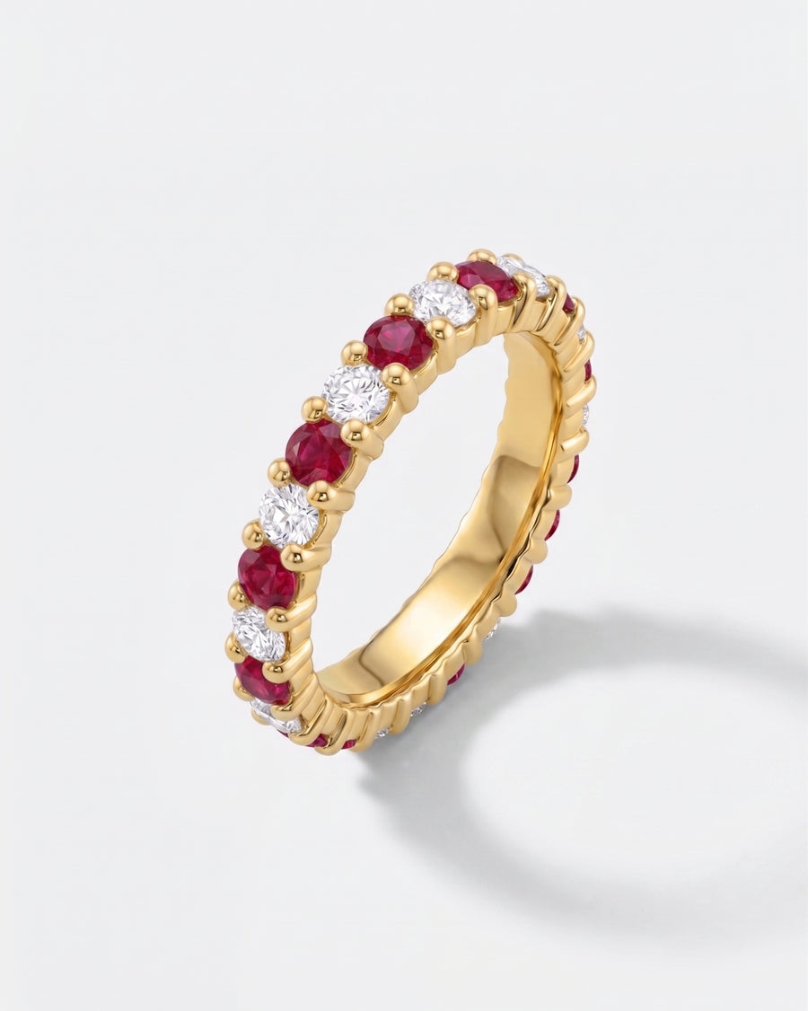 Gold full eternity ring with alternating claw-set rubies and diamonds.