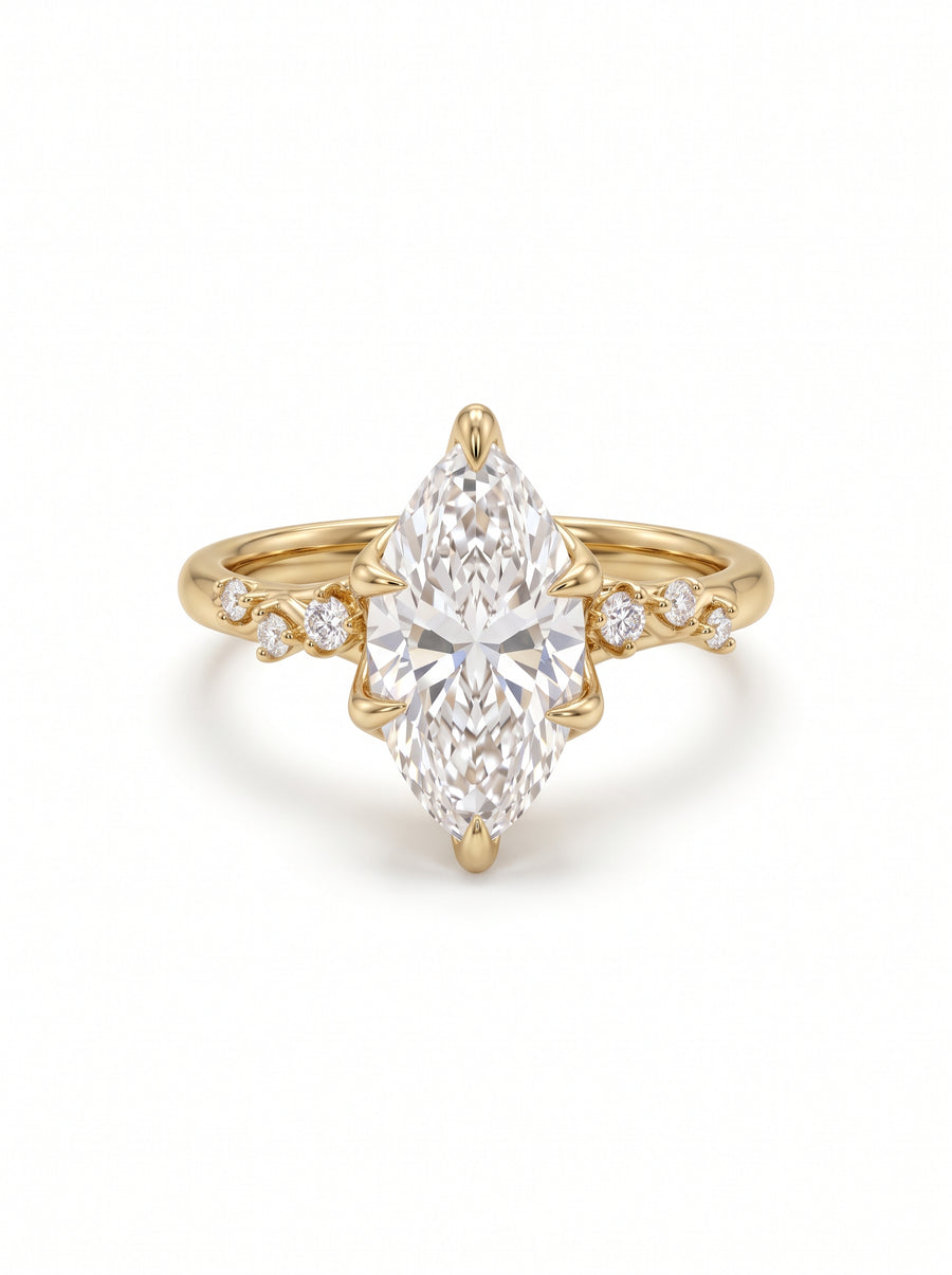 Marquise-cut lab-grown diamond engagement ring in yellow gold with a floral vine band and accent stones.