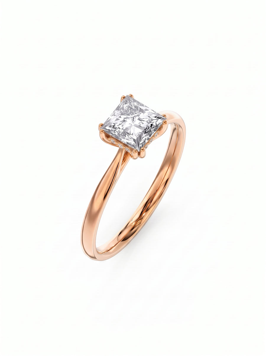 Princess cut diamond engagement ring with a hidden halo set in a polished rose gold band.