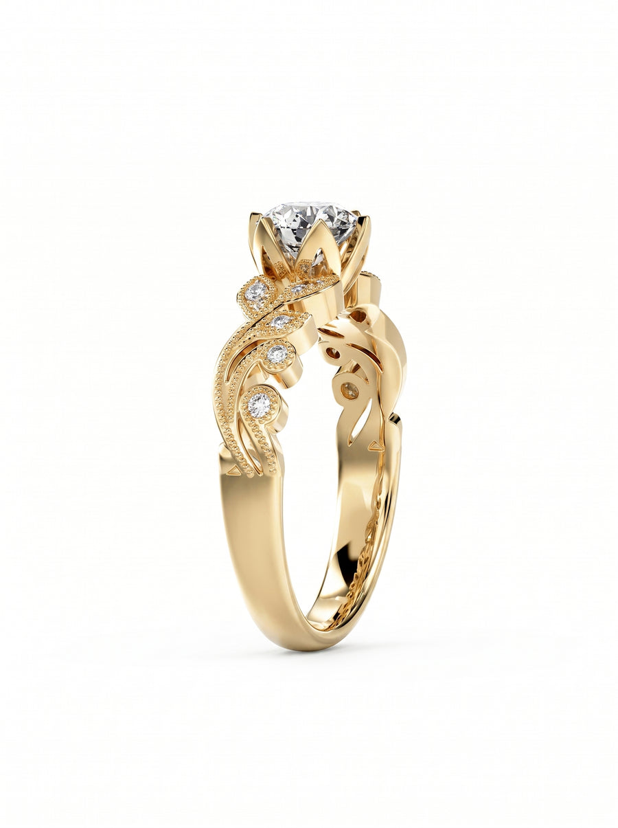Gold engagement ring with a round cut diamond, floral filigree accents, and small pavé set side stones.