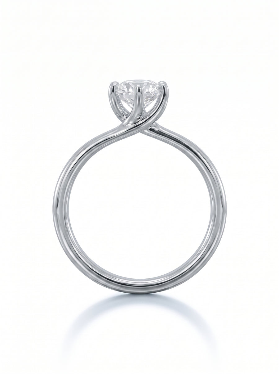 Oval diamond engagement ring in polished white gold with a twisted band design.