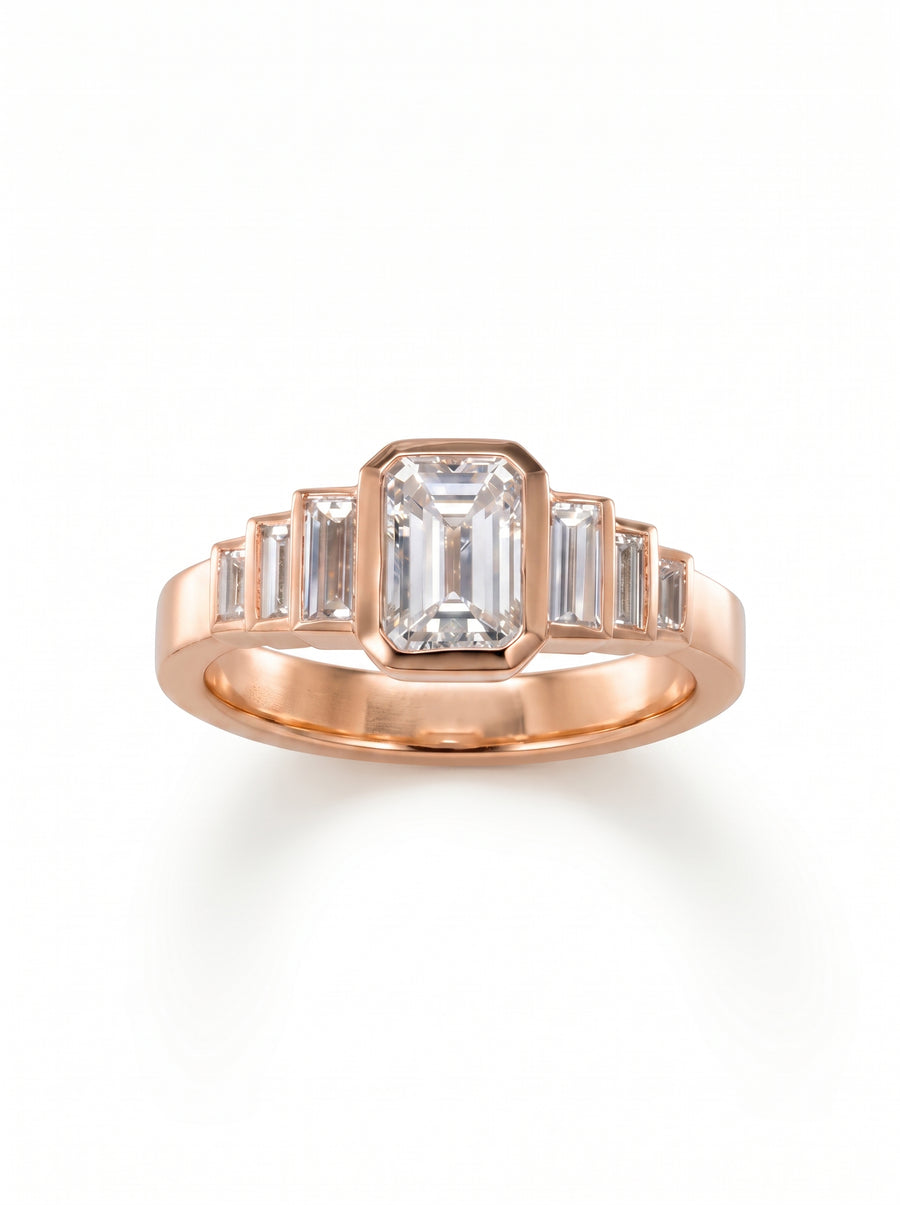 Rose gold engagement ring featuring a central emerald cut diamond flanked by six baguette cut side stones.