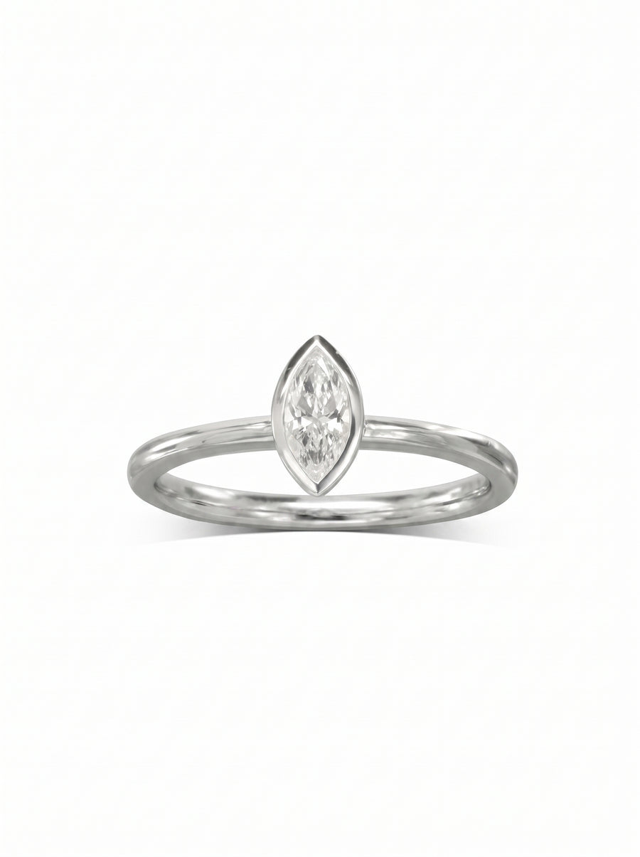 Marquise cut diamond engagement ring set in a polished silver-tone bezel band on a white background.