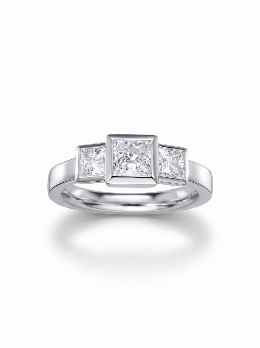 Trilogy engagement ring with three princess cut diamonds set in a polished platinum band.