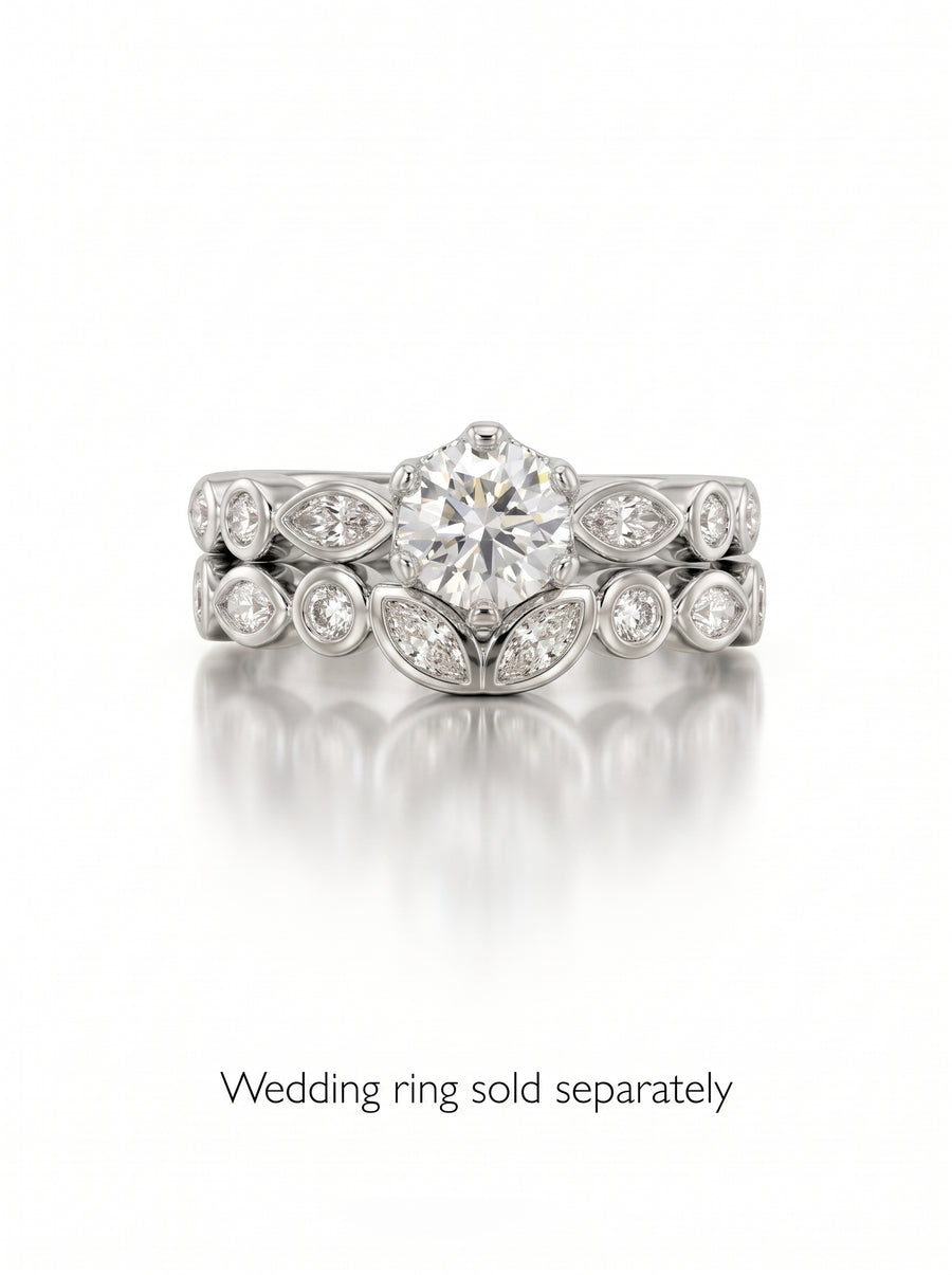Round cut diamond engagement ring in silver with marquise and round accent stones in a crown setting.
