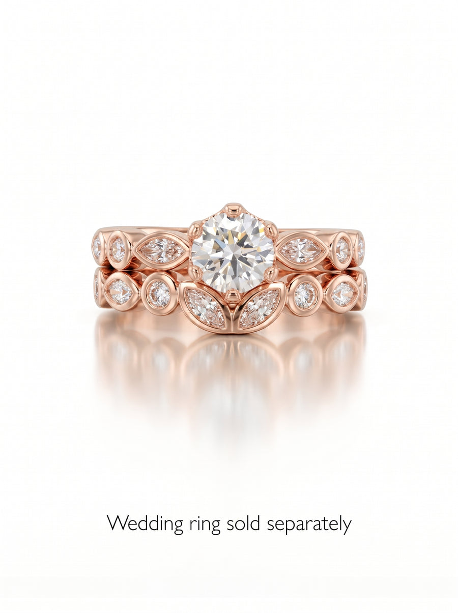 Round cut diamond engagement ring in rose gold with a crown-style setting and marquise accent stones.