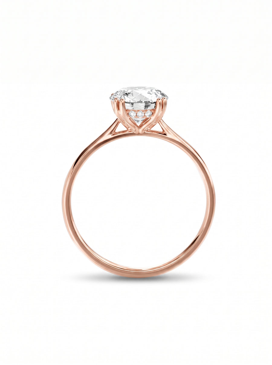 Round cut diamond engagement ring in rose gold with a hidden halo setting.