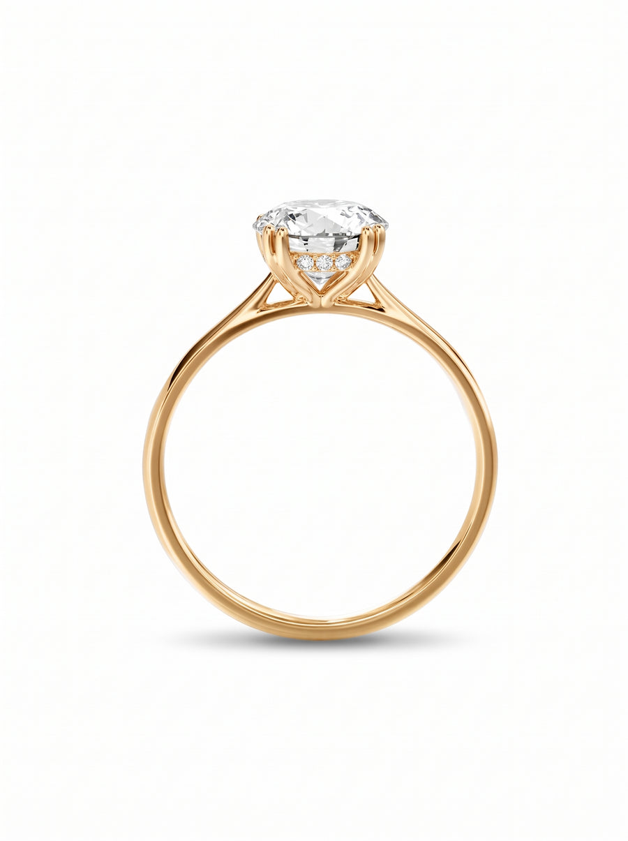 Round cut diamond engagement ring with a hidden halo on a polished yellow gold band.