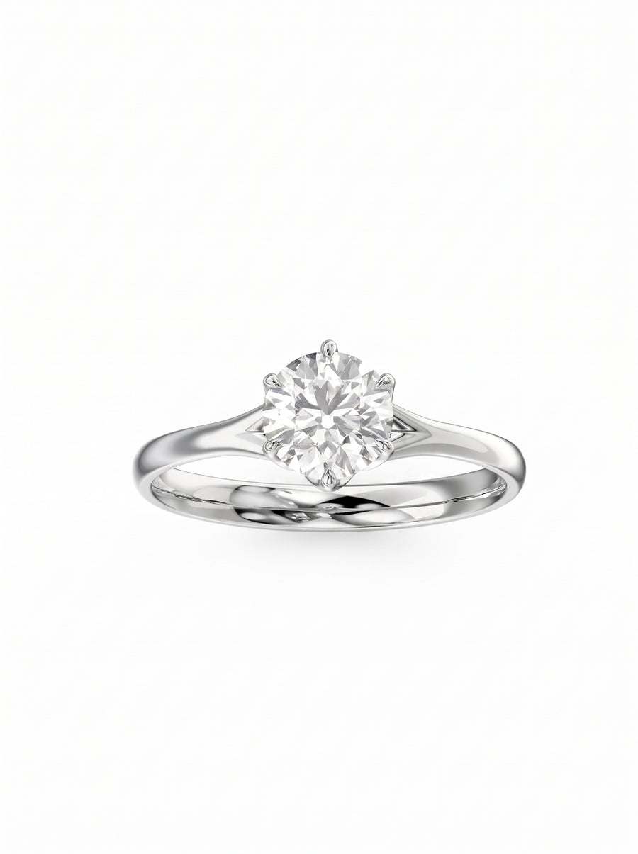 Round cut diamond engagement ring in polished platinum with a six-prong tulip claw setting.