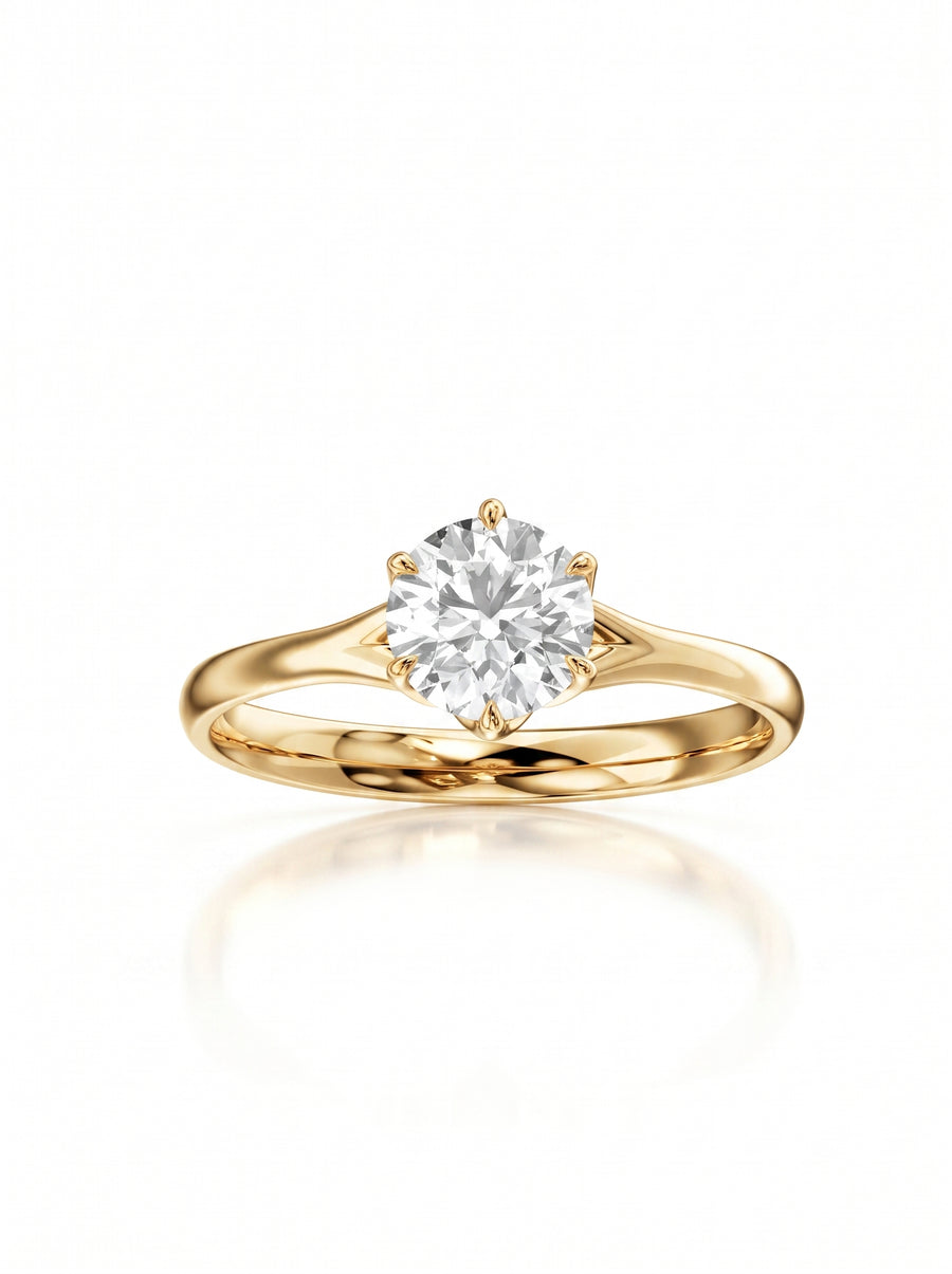Round cut diamond engagement ring in 18k yellow gold with a six-prong tulip claw setting.