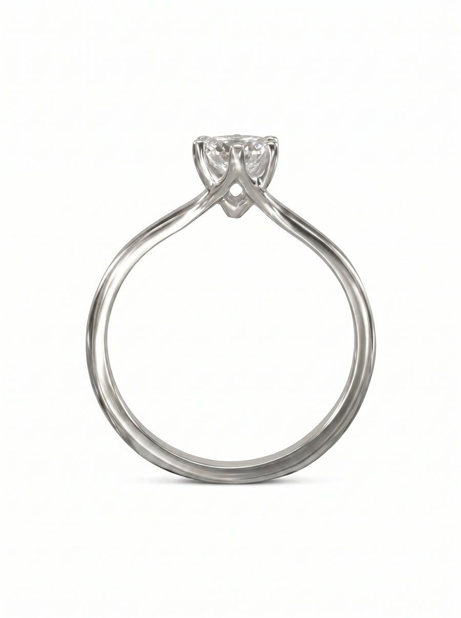 Silver solitaire engagement ring with a round diamond in a six-claw v-shaped setting on a plain band.