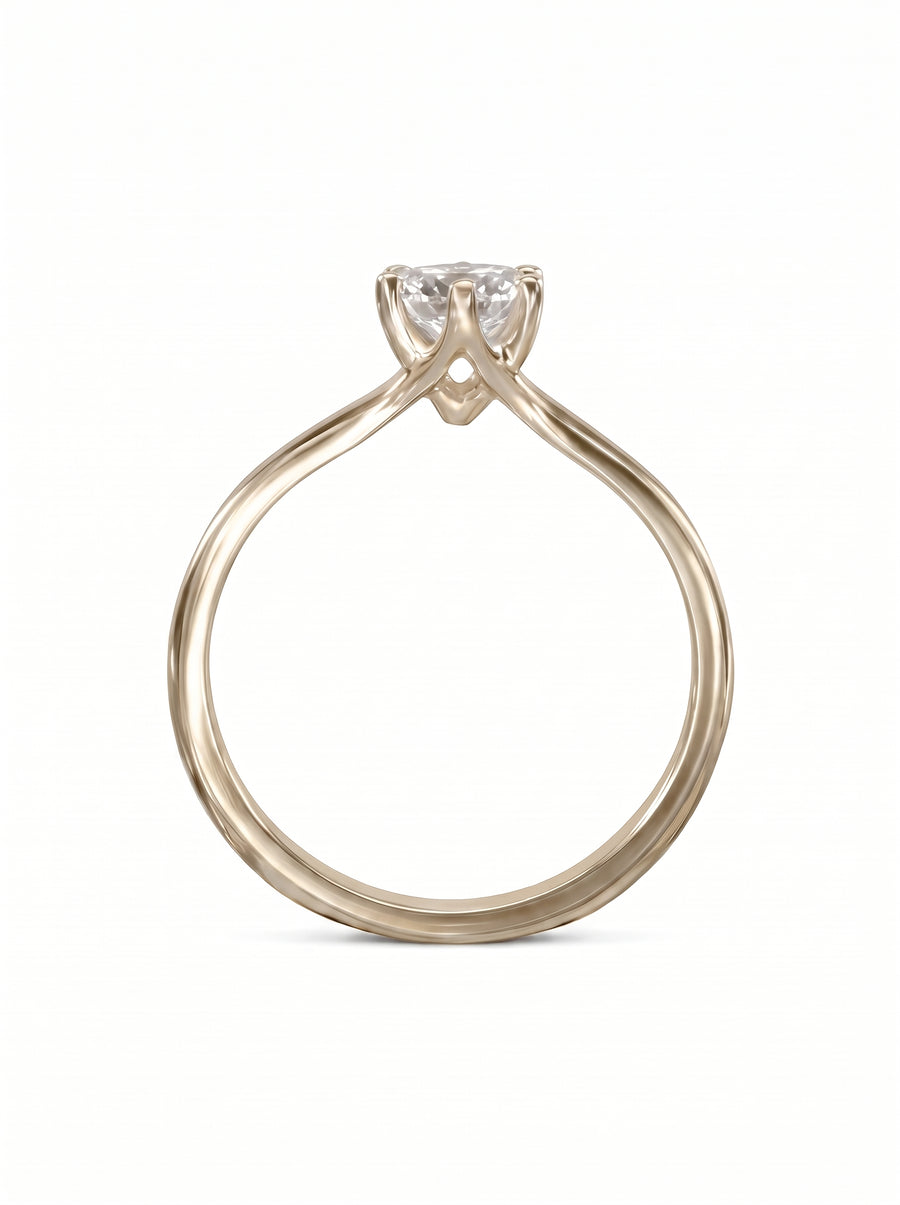 Solitaire engagement ring in yellow gold with a six-claw V setting and a round brilliant cut diamond.