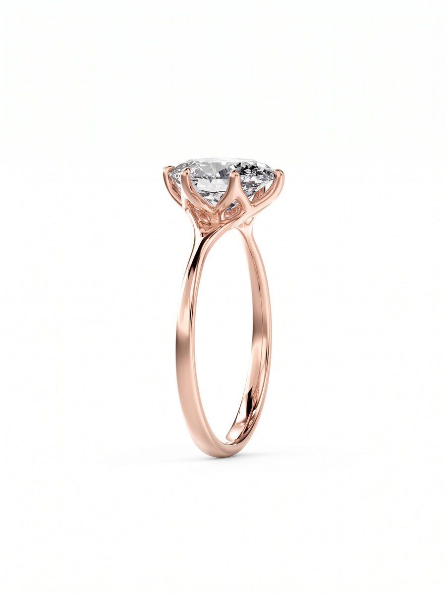 Oval cut diamond engagement ring in rose gold with a tulip-shaped claw setting.