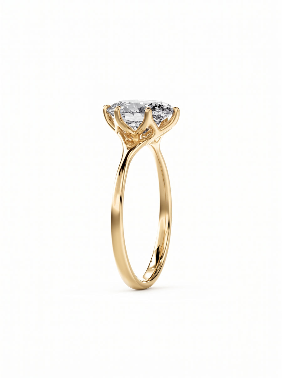 Oval cut diamond engagement ring in 18k yellow gold with a tulip-shaped claw setting.