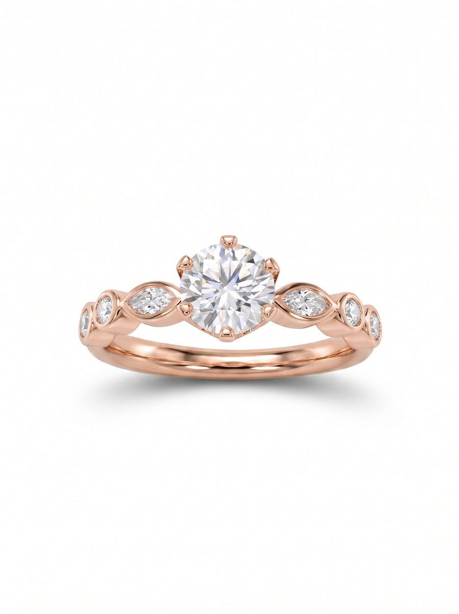Rose gold engagement ring featuring a round center diamond and marquise side stones on a polished band.