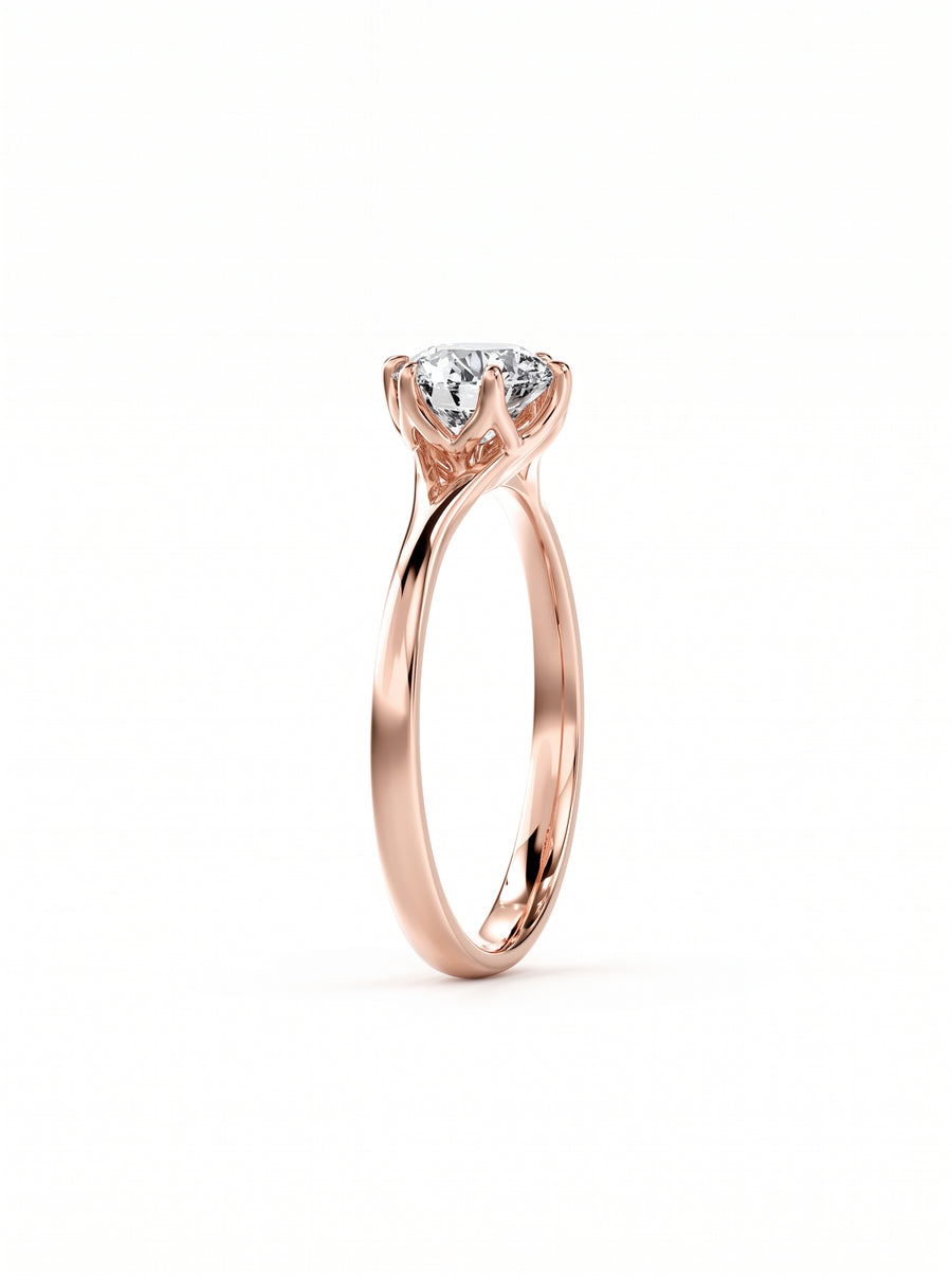 Round cut diamond engagement ring in rose gold with a tulip-style claw setting.