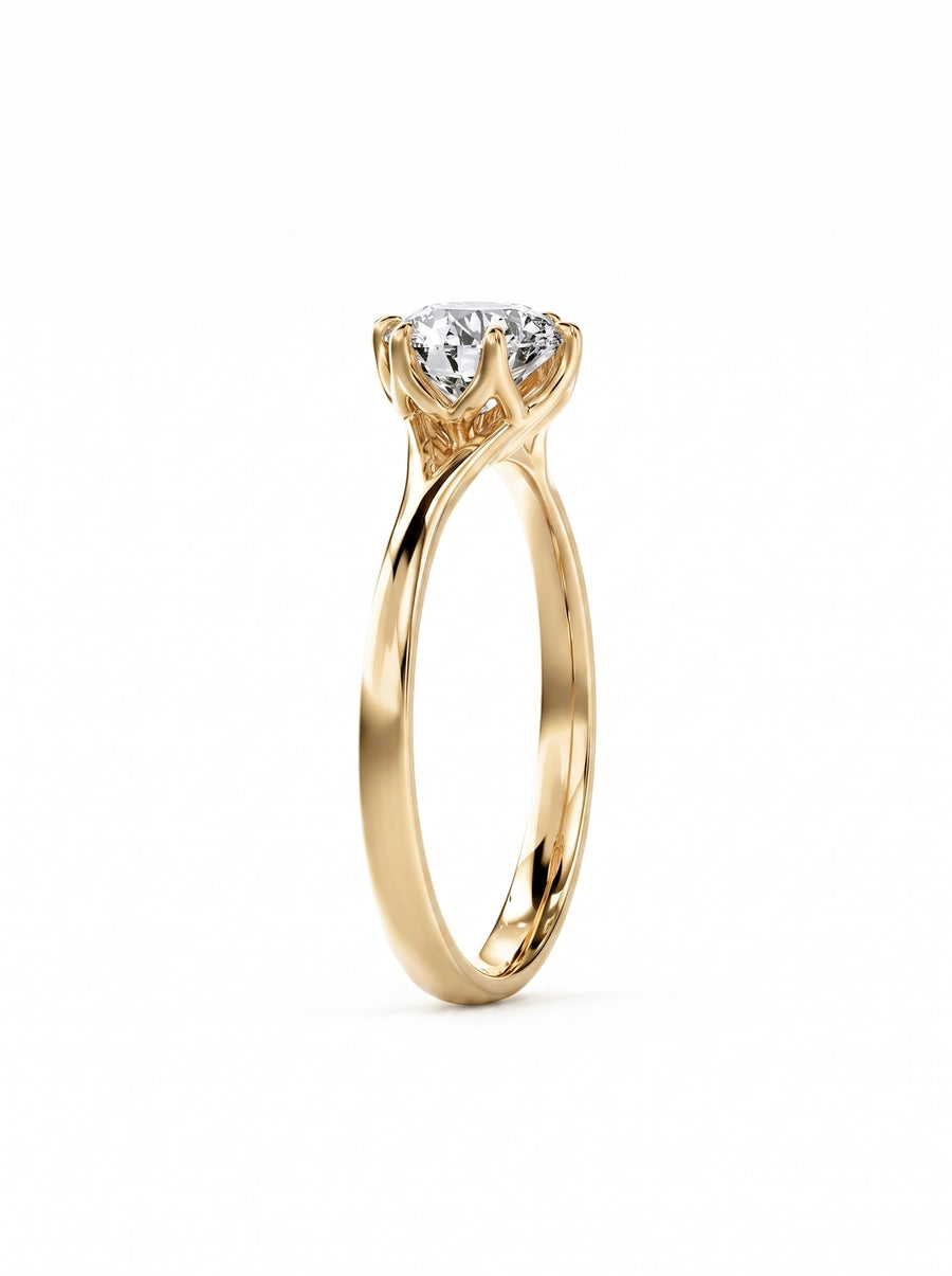 Round cut diamond engagement ring in 14k yellow gold with a tulip-shaped claw setting.