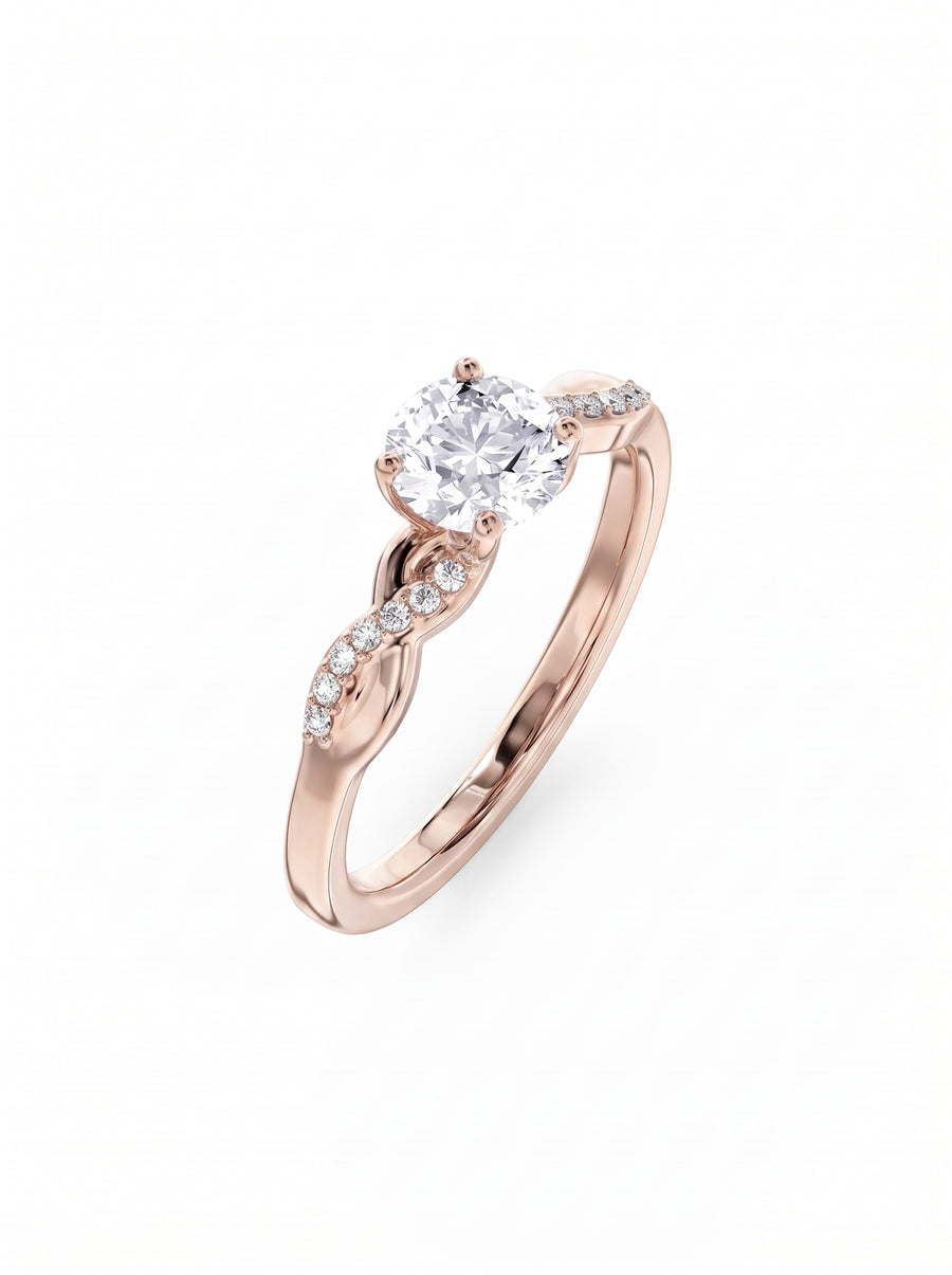 Rose gold engagement ring with a round cut diamond and a twisted band featuring small pavé diamonds.