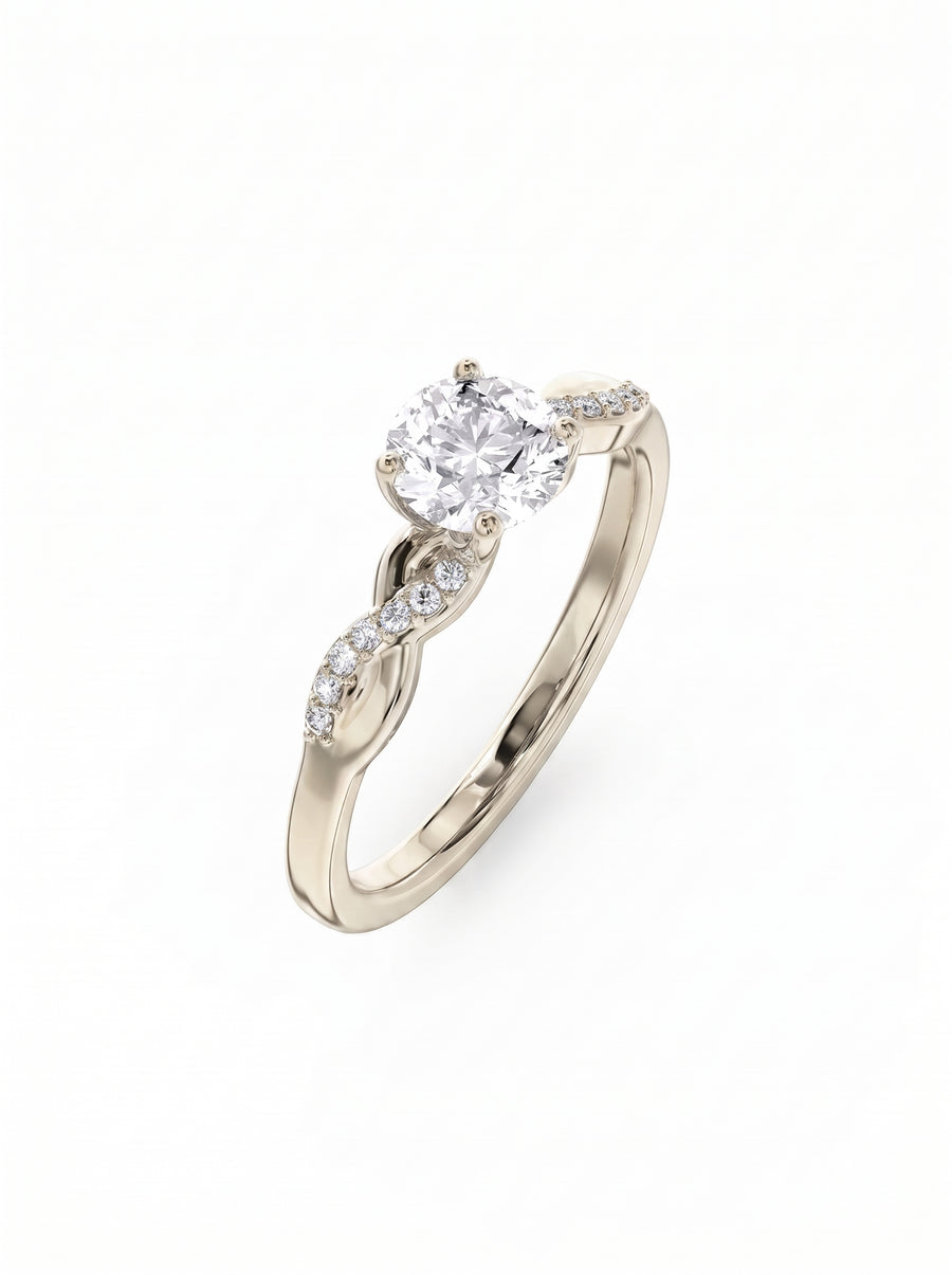 Round cut diamond engagement ring with a twisted gold band and pavé set side stones.
