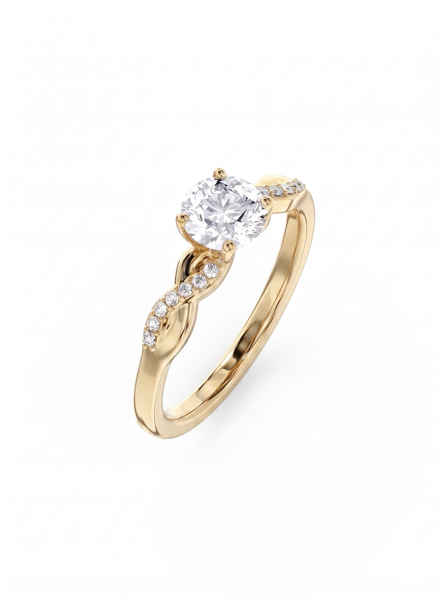 Round cut diamond engagement ring in yellow gold with a twisted band and pavé set side stones.