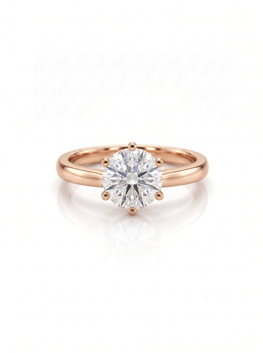 Round brilliant diamond engagement ring with a six-claw setting on a polished rose gold band.