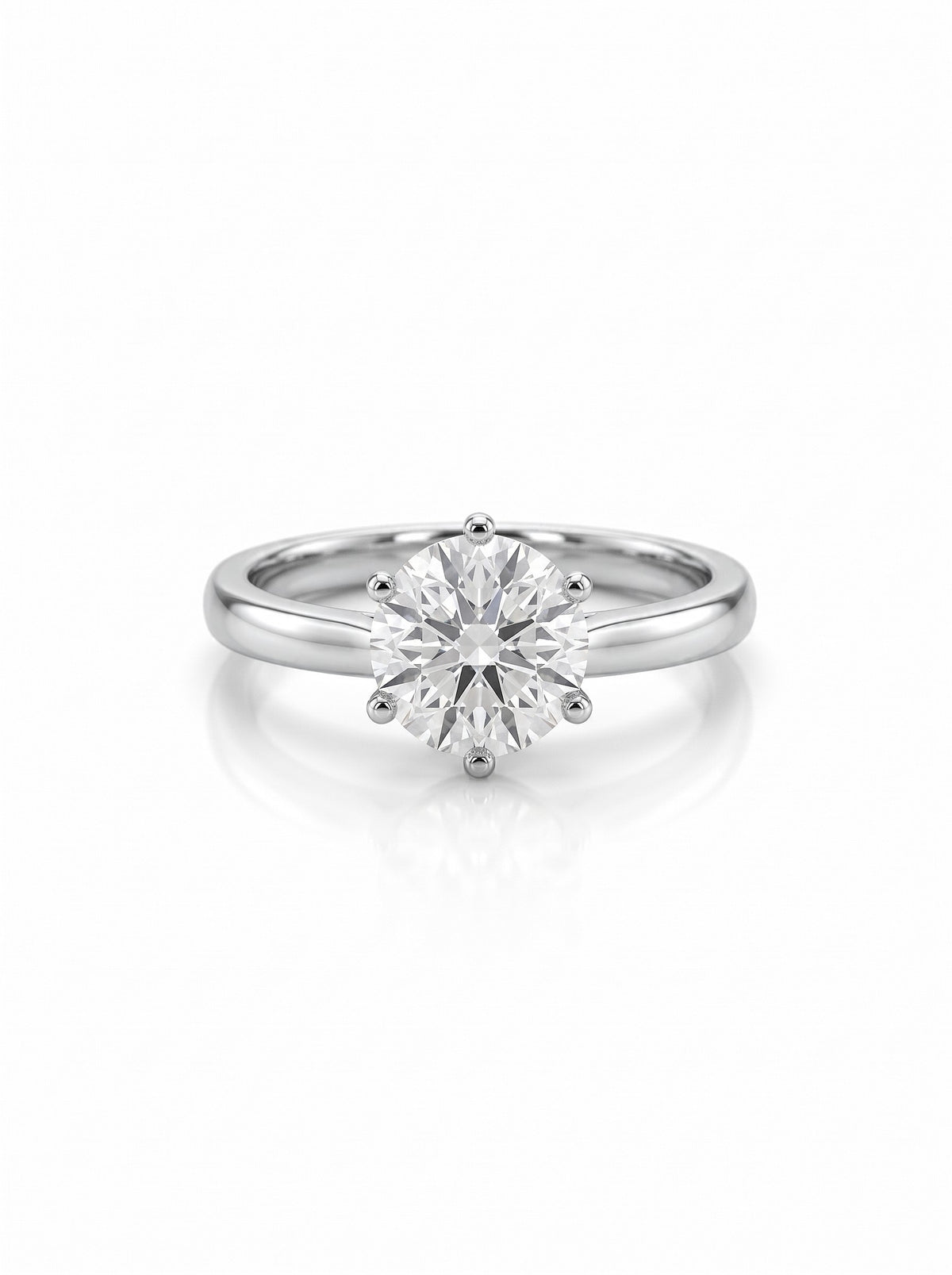 Round brilliant cut diamond solitaire engagement ring in a six-claw platinum setting on a white background.