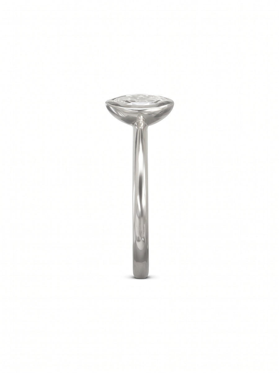 Marquise cut diamond engagement ring in a silver-toned bezel setting on a plain metal band.