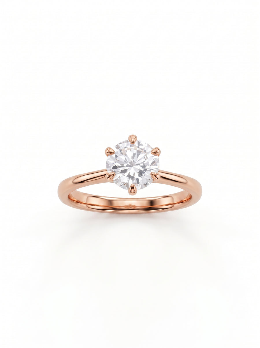 Round cut solitaire diamond engagement ring set in a polished rose gold band with six prongs.