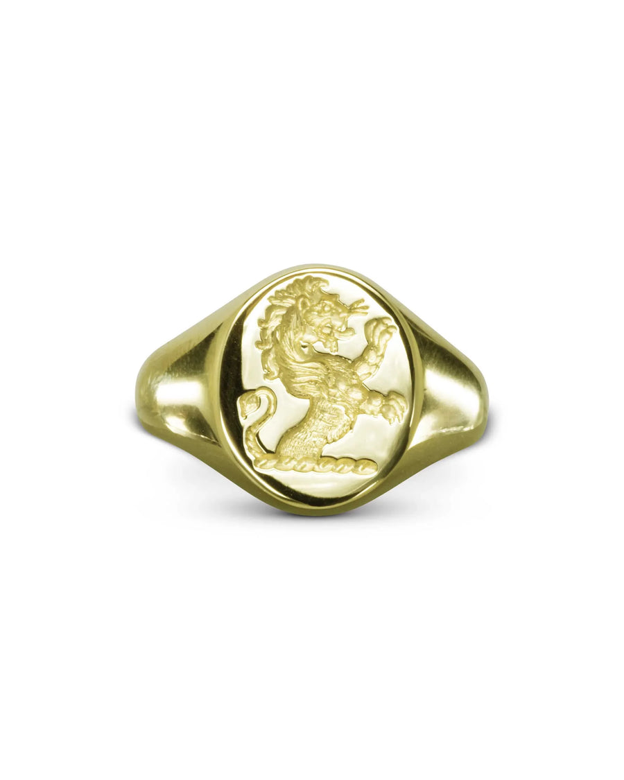 Handcrafted gold signet ring with an engraved rampant lion design on white background