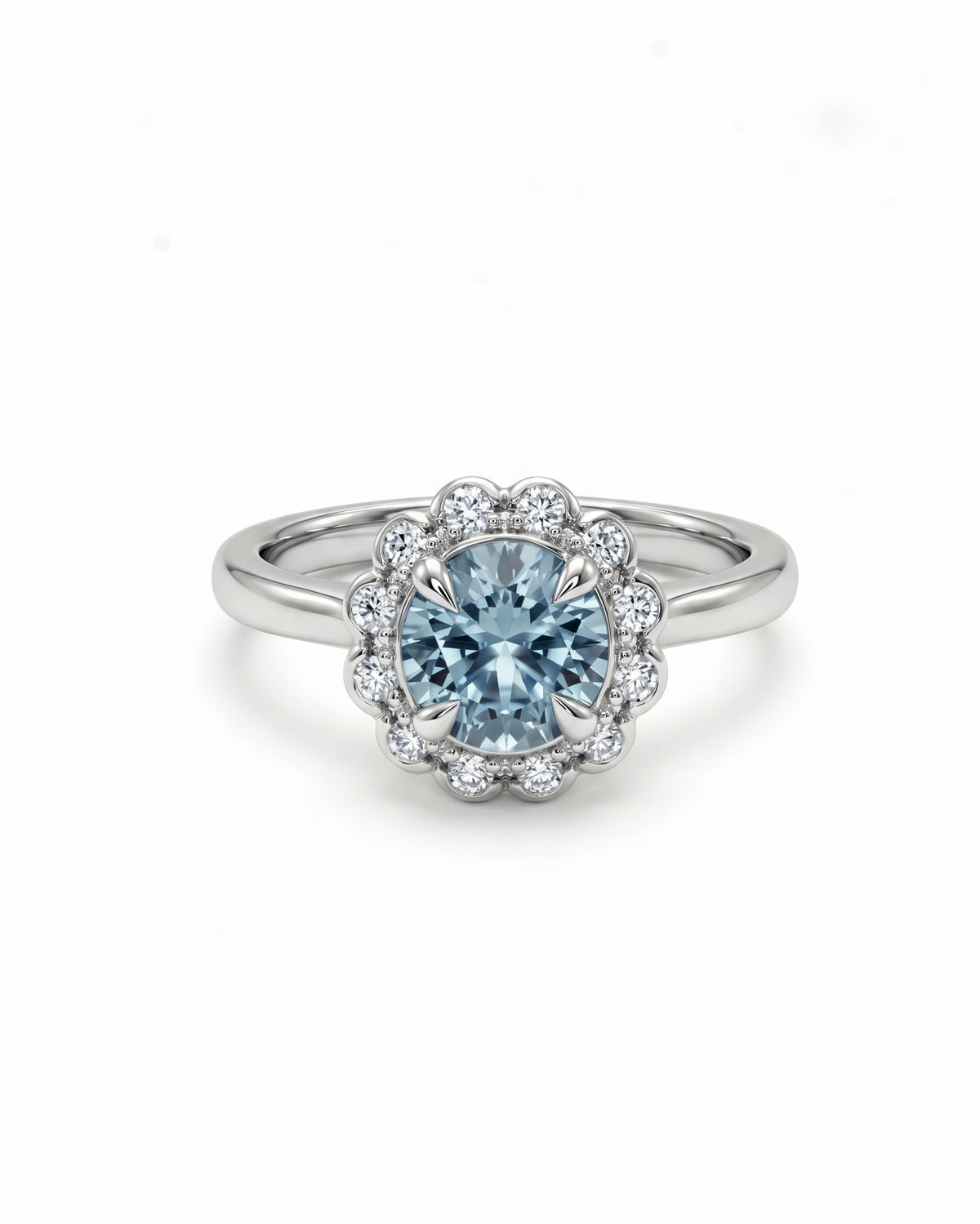 Round aquamarine ring in white gold with a scalloped diamond cluster halo setting.