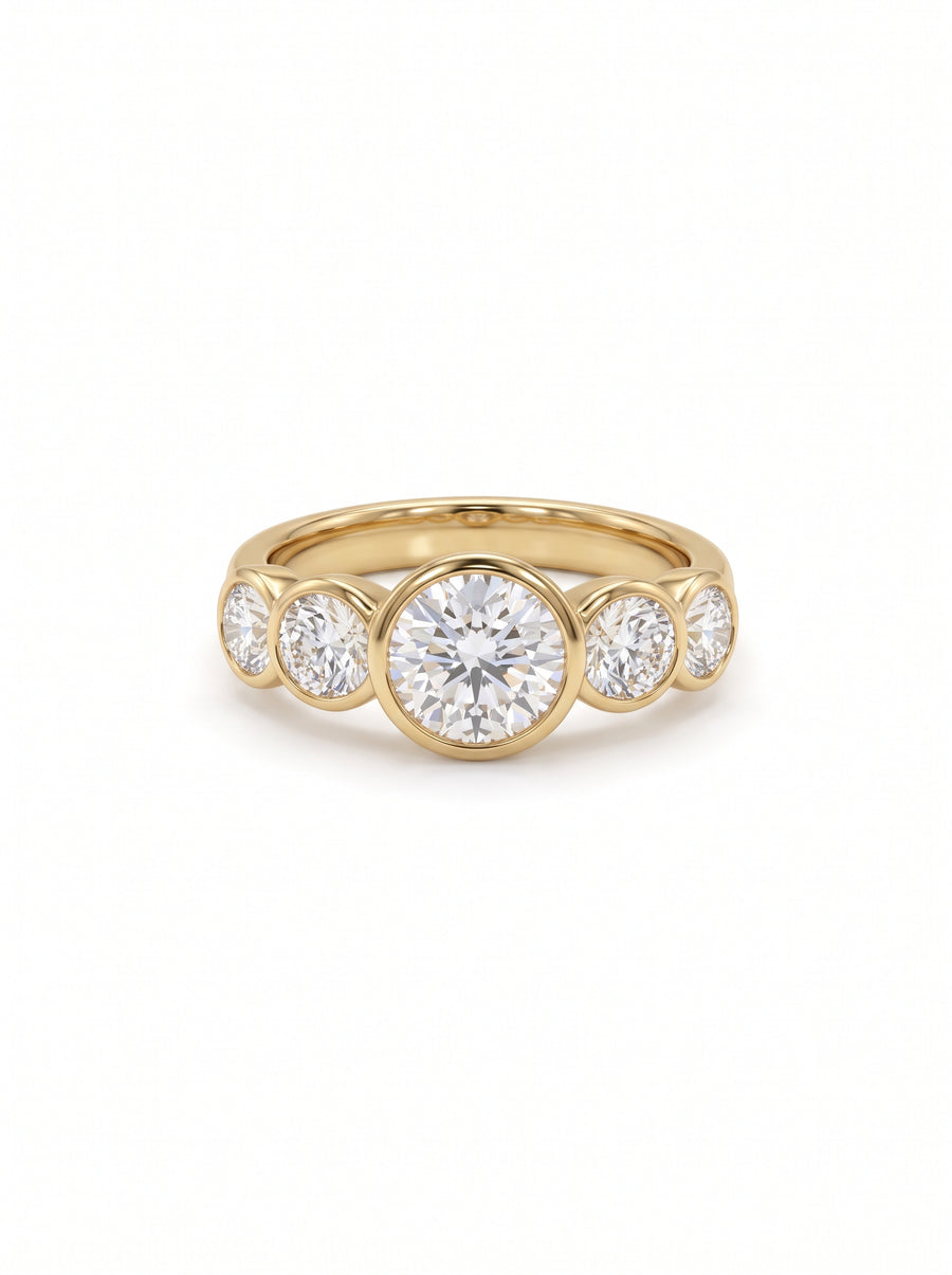 Yellow gold ring with five round brilliant cut diamonds in a bezel setting.