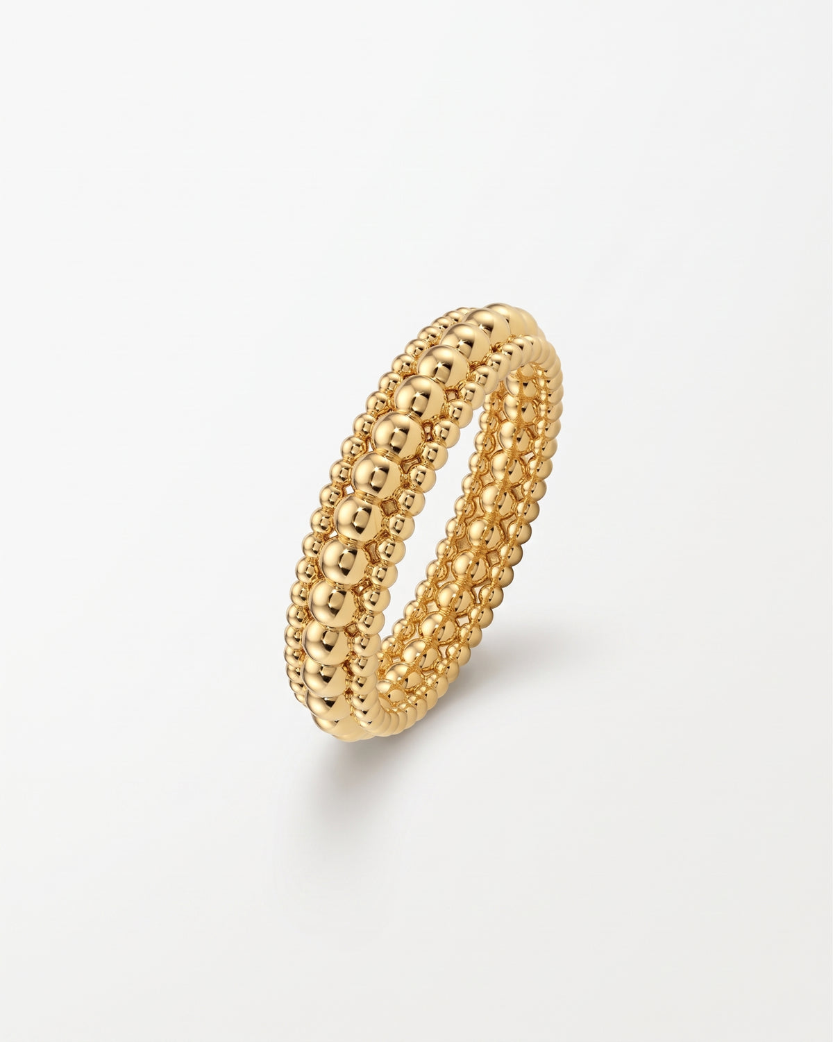 Gold three-row ring featuring a stack of polished beaded bands in a minimalist design.