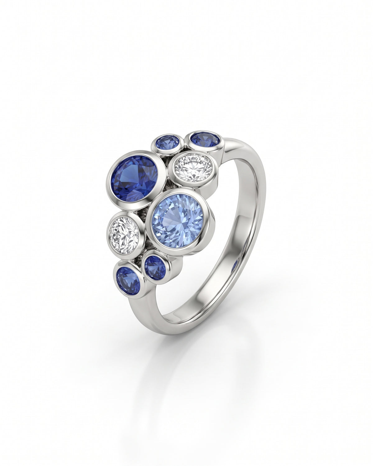 Platinum cluster ring featuring round blue sapphires and diamonds in a bezel-set bubble design.