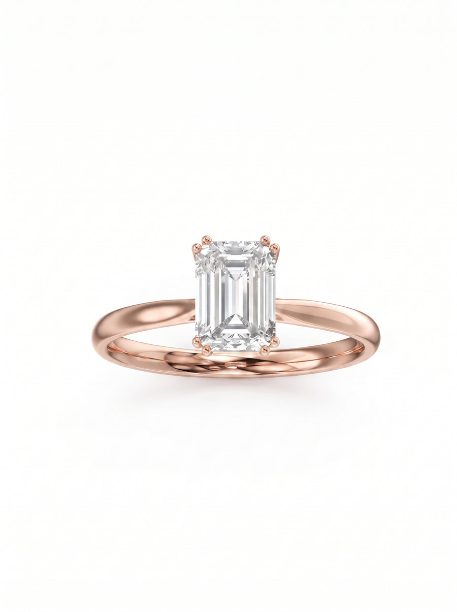 Emerald cut diamond engagement ring with a hidden halo set in a polished rose gold band.