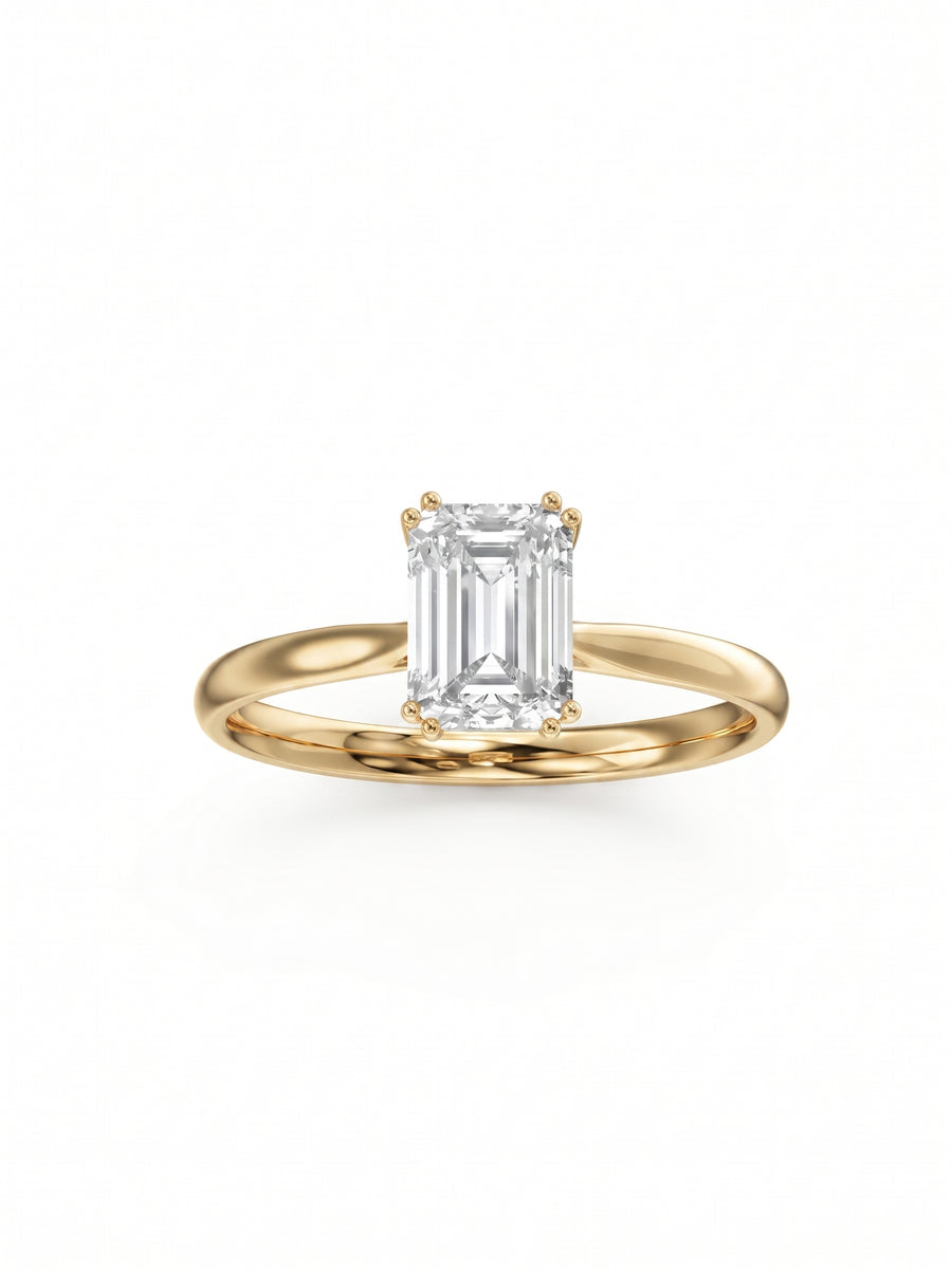 Emerald cut diamond engagement ring with a hidden halo on a polished yellow gold band.