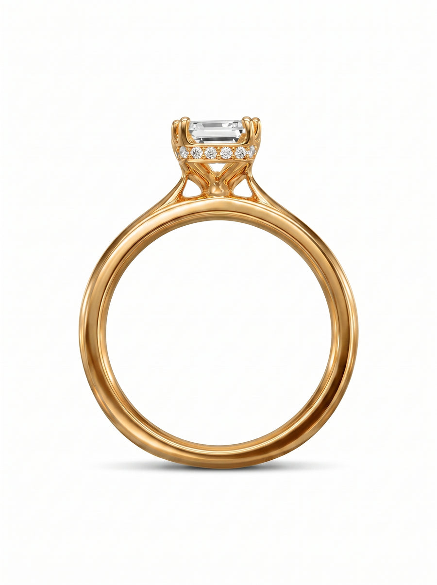 Emerald cut diamond engagement ring in yellow gold with a diamond hidden halo setting.