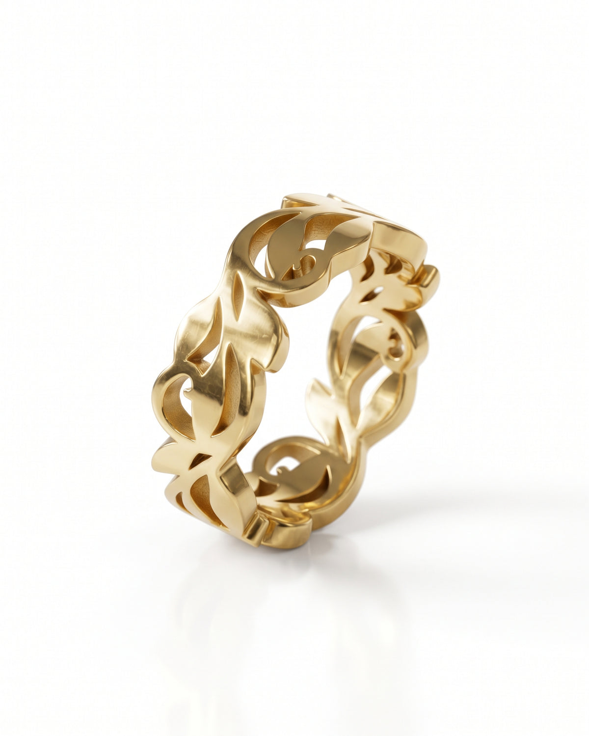 Gold band ring featuring an intricate cutout floral leaf pattern in a polished metallic finish.