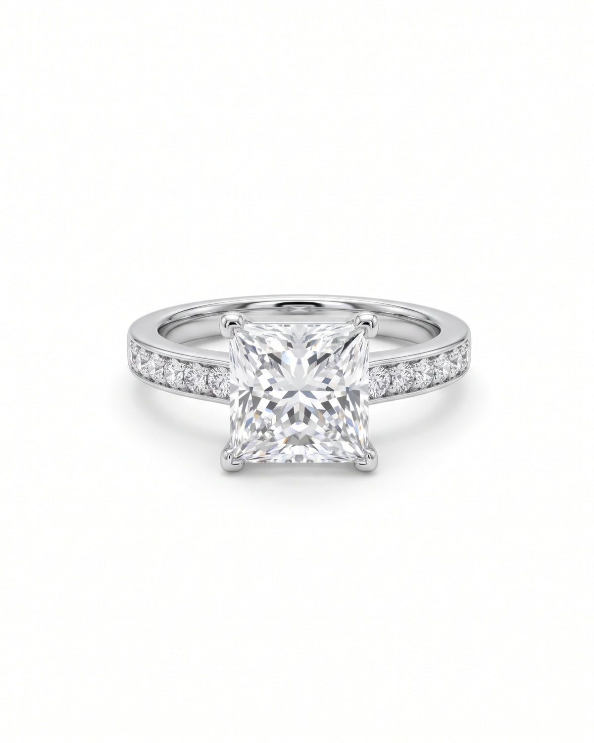 Princess cut diamond engagement ring in platinum with a four-claw setting and pavé diamond band.
