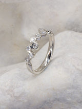 Half water bubbles eternity ring on stone background