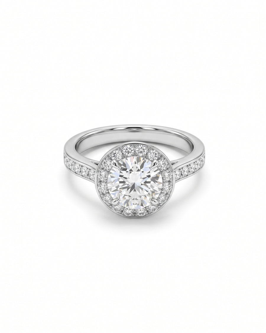 Round diamond engagement ring with a halo setting and pavé diamonds on a silver band.