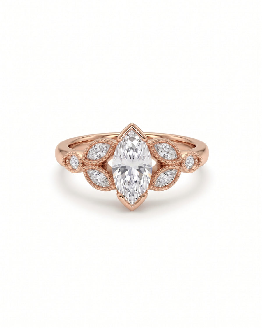 Rose gold engagement ring featuring a central marquise cut diamond surrounded by smaller marquise and round accent stones.