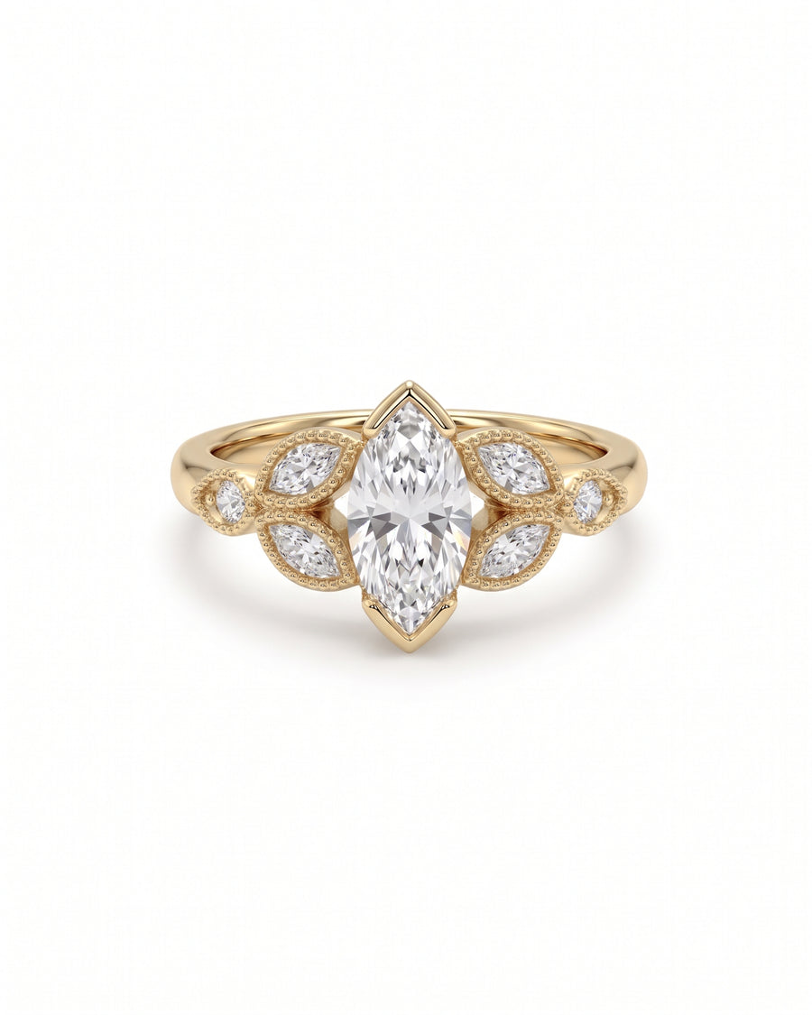 Gold engagement ring featuring a central marquise cut diamond accented by smaller marquise and round side stones.