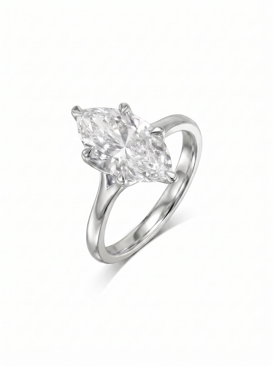 Marquise cut diamond engagement ring set in a silver-toned metal band with a four-prong tulip setting.
