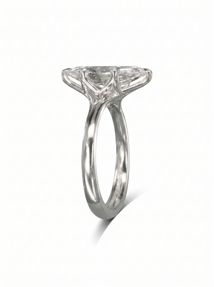 Marquise cut diamond engagement ring in polished platinum with a tulip-style claw setting.
