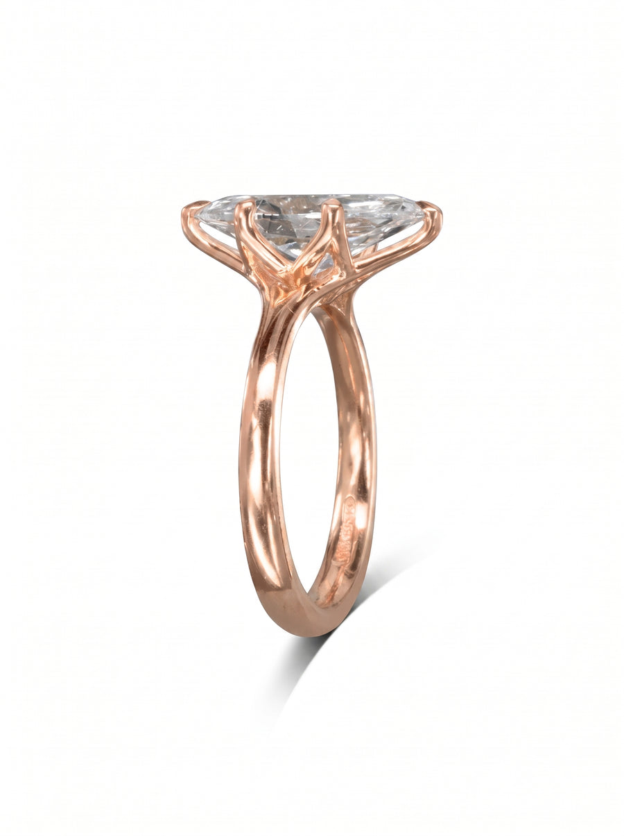 Marquise cut diamond engagement ring set in a rose gold tulip claw setting on a white background.