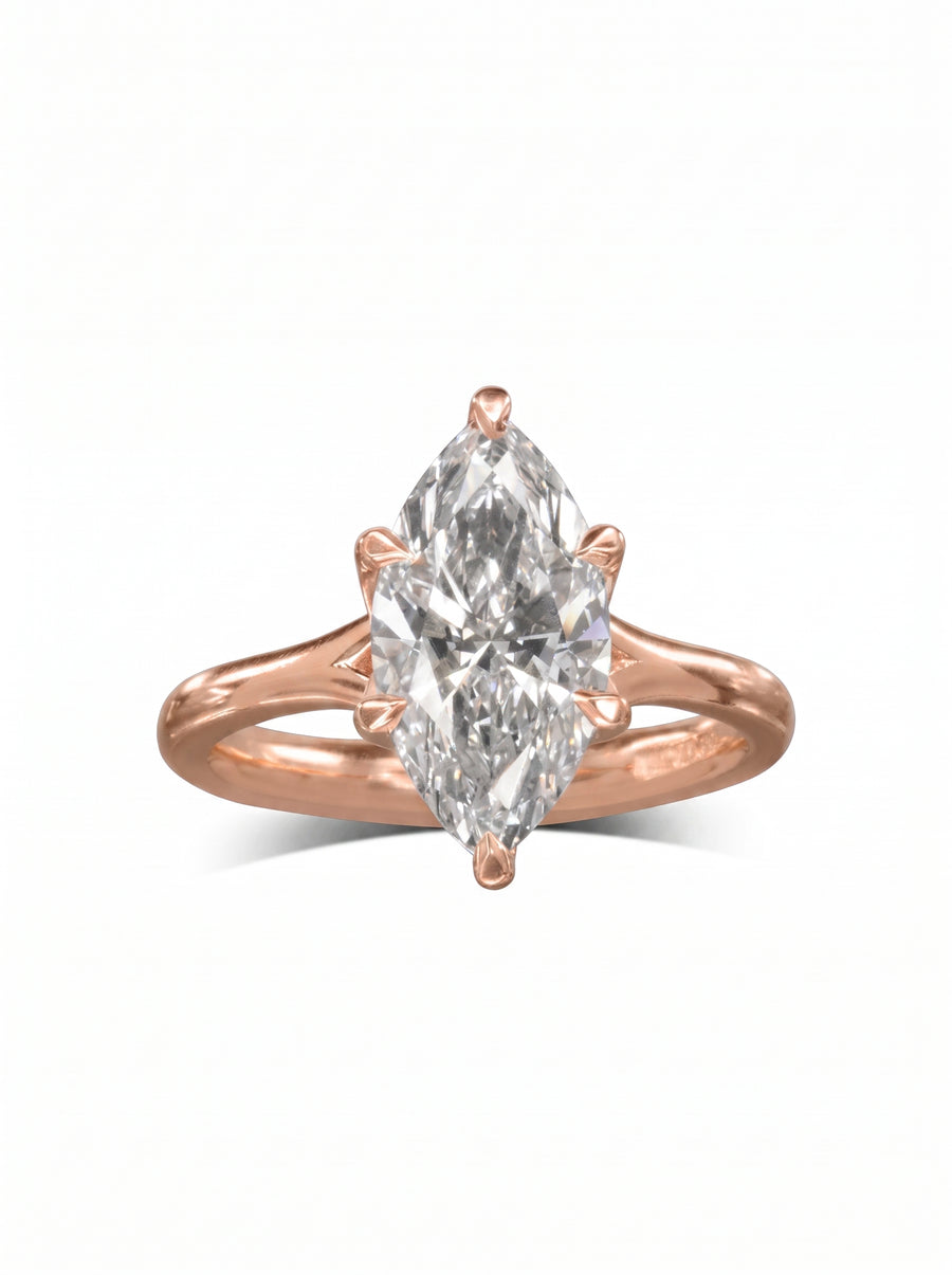Marquise cut diamond engagement ring set in a rose gold tulip claw setting on a plain band.